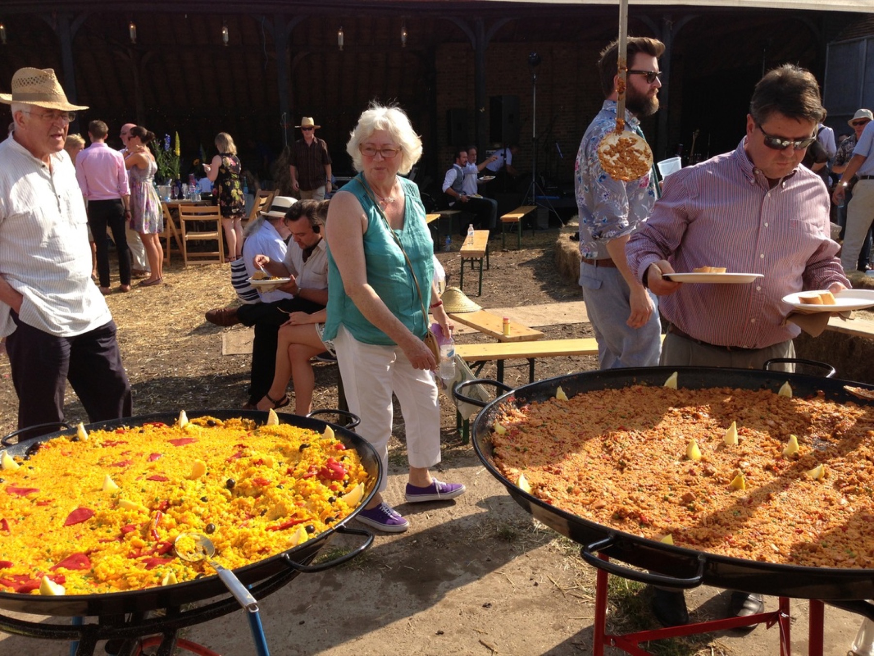 Guests being served paella at a private garden party